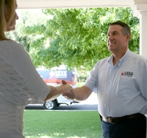 An American Leak Detection of Louisville specialist smiling and shaking a customer’s hand  in greeting before gas line repair 