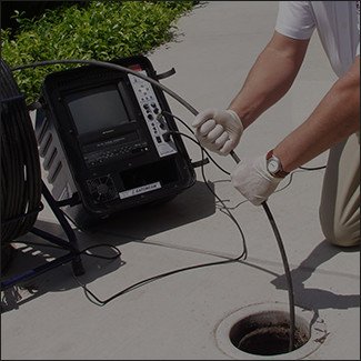 american leak detection technician performing a sewer line video inspection in winston-salem 